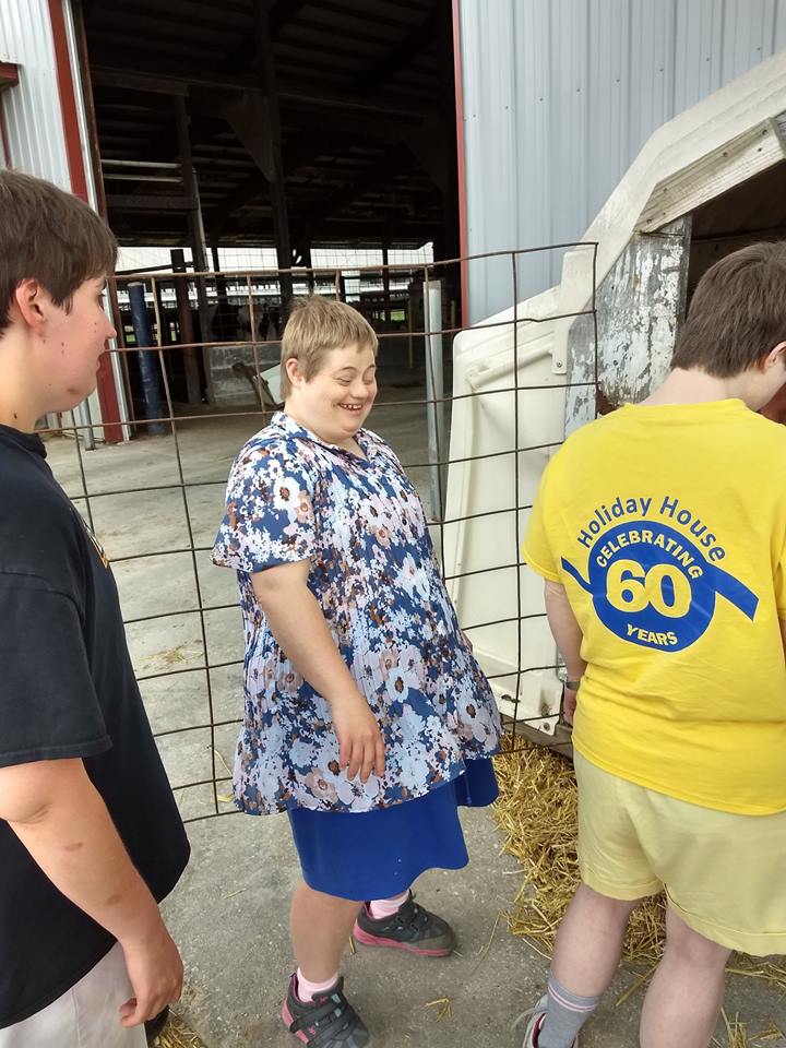 Ascend Service participants in front of calf hutch